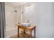 Bathroom with a rustic wooden vanity and tiled shower/tub combo at 12912 Ironstone Way # 101, Parker, CO 80134