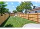 Large backyard with a newly installed wooden fence, and well-manicured lawn at 4465 N Umatilla St, Denver, CO 80211