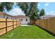 Well-maintained backyard with lush green grass, surrounded by a wooden privacy fence at 4465 N Umatilla St, Denver, CO 80211