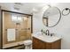 Modern bathroom features a tiled shower, stylish vanity, and sleek black fixtures for a spa-like experience at 4465 N Umatilla St, Denver, CO 80211