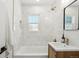 Beautiful bathroom features updated tile, shower, and gold accents for a sleek and stylish aesthetic at 4465 N Umatilla St, Denver, CO 80211