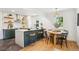 Modern kitchen features stainless steel appliances, a spacious island, and barstool seating at 4465 N Umatilla St, Denver, CO 80211
