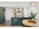 Open concept kitchen with island seating, stainless appliances, floating shelves and hardwood floors at 4465 N Umatilla St, Denver, CO 80211