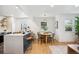 Contemporary kitchen open to the dining area with updated appliances and a sleek island at 4465 N Umatilla St, Denver, CO 80211