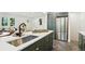 Spacious kitchen with island sink, stainless steel appliances, and open layout at 4465 N Umatilla St, Denver, CO 80211