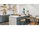 Well-appointed kitchen with island seating, stylish decor, and sleek appliances at 4465 N Umatilla St, Denver, CO 80211