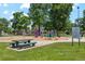 Community playground with swings, slides, and various play structures surrounded by green space at 4465 N Umatilla St, Denver, CO 80211