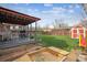 A spacious backyard with a furnished covered patio, a sandbox, and a storage shed at 1320 Quari St, Aurora, CO 80011