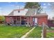 Backyard view featuring a well-maintained lawn and a covered deck perfect for outdoor entertaining at 1320 Quari St, Aurora, CO 80011