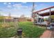Beautiful backyard with a furnished covered patio and a large grassy space at 1320 Quari St, Aurora, CO 80011