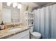 Bright bathroom featuring a granite countertop and white shelving for storage at 1320 Quari St, Aurora, CO 80011