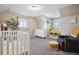 Comfortable carpeted bedroom featuring lots of natural light and neutral walls at 1320 Quari St, Aurora, CO 80011