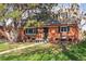 Charming brick home featuring a cozy front porch and a well-manicured lawn, providing an inviting curb appeal at 1320 Quari St, Aurora, CO 80011