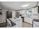 Updated kitchen with white cabinets, subway tile backsplash, and a center island with bar seating at 1320 Quari St, Aurora, CO 80011