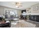 Bright and cozy living room featuring a fireplace, ceiling fan, and ample natural light at 1320 Quari St, Aurora, CO 80011