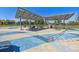 Outdoor playground area features colorful play surfaces and shaded picnic tables for Gathering-friendly fun at 1320 Quari St, Aurora, CO 80011