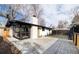 A white brick home showcasing a backyard space with a patio and detached garage at 2435 S Meade St, Denver, CO 80219