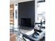 Living room featuring a black brick fireplace, hardwood floors, and many windows at 2435 S Meade St, Denver, CO 80219