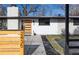 Modern home exterior with unique address numbers and a wood-slat door at 2435 S Meade St, Denver, CO 80219