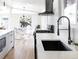 Bright, modern kitchen features stainless steel appliances with an open floor plan view to dining room at 2435 S Meade St, Denver, CO 80219