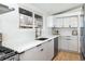 Kitchen boasting stainless steel appliances, white countertops and tiled backsplash at 2435 S Meade St, Denver, CO 80219