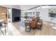 Bright living room featuring a black brick fireplace, hardwood floors, and many windows at 2435 S Meade St, Denver, CO 80219