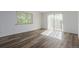 Bedroom with wood-style flooring and natural light from the large window and door at 7755 E Quincy Ave # 308A5, Denver, CO 80237