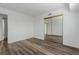 This bedroom features stylish wood flooring and a mirrored closet, offering both aesthetics and functionality at 7755 E Quincy Ave # 308A5, Denver, CO 80237