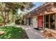 Inviting clubhouse entrance with lush landscaping, offering a welcoming space for community gatherings at 7755 E Quincy Ave # 308A5, Denver, CO 80237