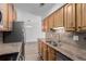 Updated kitchen features granite countertops, stainless steel appliances and wood cabinets at 7755 E Quincy Ave # 308A5, Denver, CO 80237
