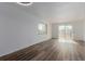 Bright living room with wood-style flooring and sliding glass door to balcony at 7755 E Quincy Ave # 308A5, Denver, CO 80237