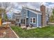 Well-maintained backyard with patio, lawn, fence, and mature trees, ideal for outdoor enjoyment at 10743 W Berry Pl, Littleton, CO 80127