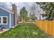 Grassy backyard with wooden fences offering privacy at 10743 W Berry Pl, Littleton, CO 80127
