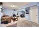 Carpeted basement featuring blue painted walls and space for a relaxing living space at 10743 W Berry Pl, Littleton, CO 80127