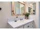 Bright bathroom featuring a marble countertop vanity and a wood framed mirror at 10743 W Berry Pl, Littleton, CO 80127