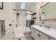 Bright bathroom featuring a bathtub and shower combo, marble countertops, and ample lighting at 10743 W Berry Pl, Littleton, CO 80127