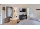 Bright bedroom featuring an ensuite bathroom, a fireplace, and ample closet space at 10743 W Berry Pl, Littleton, CO 80127