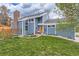 Inviting home featuring a charming front yard, brick chimney, and attractive light-blue siding at 10743 W Berry Pl, Littleton, CO 80127