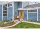 Close up of entry showing the natural wood front door, bench and drought-tolerant garden at 10743 W Berry Pl, Littleton, CO 80127