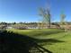 A peaceful park setting with a picnic table by the tranquil lake, perfect for relaxation and enjoying the natural landscape at 10743 W Berry Pl, Littleton, CO 80127