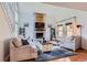 Bright living room with a vaulted ceiling, fireplace and staircase with white railings at 10743 W Berry Pl, Littleton, CO 80127