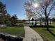 Picturesque park setting with a covered picnic area, playground, and serene lakeside view under a bright, sunny sky at 10743 W Berry Pl, Littleton, CO 80127