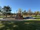 A dynamic playground with climbing structures, swings, and slides for active play, all set in a well-maintained park area at 10743 W Berry Pl, Littleton, CO 80127