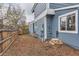 Side yard with wood fence, mulch, and mature trees, providing privacy and shade at 10743 W Berry Pl, Littleton, CO 80127