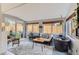 Bright sunroom features windows, a sitting area, a unique water feature, and access to the backyard at 10743 W Berry Pl, Littleton, CO 80127