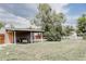 Expansive backyard with a covered patio, perfect for outdoor gatherings at 1200 S Patton Ct, Denver, CO 80219