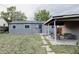 Spacious backyard featuring a covered patio for outdoor entertaining and relaxation at 1200 S Patton Ct, Denver, CO 80219