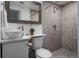 Modern bathroom featuring a vessel sink, stylish mirror, and a tiled shower at 1200 S Patton Ct, Denver, CO 80219