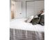 Comfortable bed with stylish pillows, a woven throw, and bright natural light at 1200 S Patton Ct, Denver, CO 80219