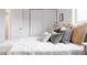 Comfortable bed with stylish pillows, a woven throw, and bright natural light at 1200 S Patton Ct, Denver, CO 80219